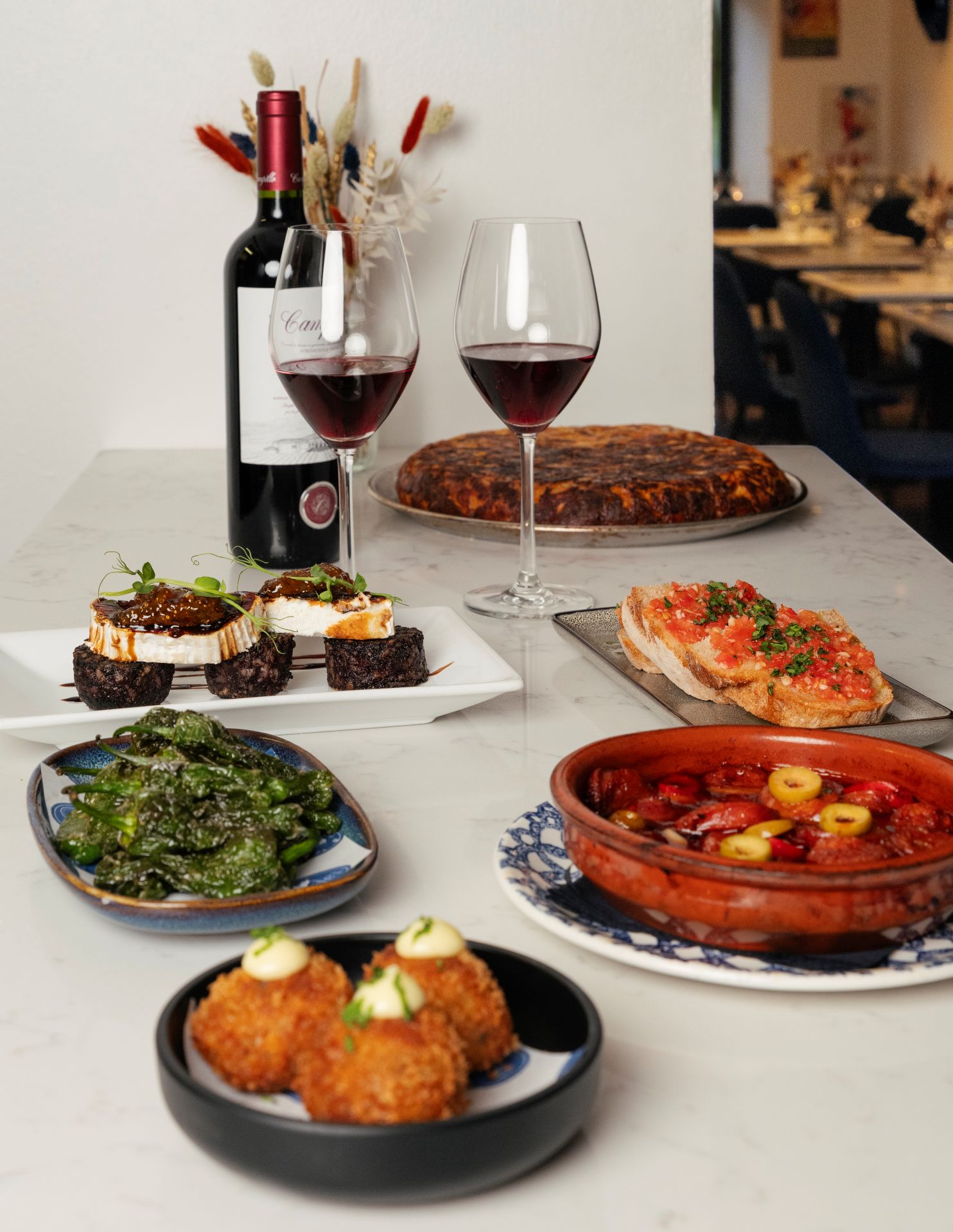 A spread of tapas dishes and red wine at Tapas 3, Edinburgh